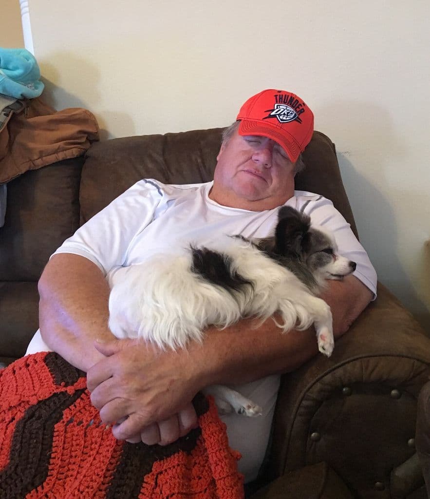 Ernie in a Thunder cap, holding his little dog