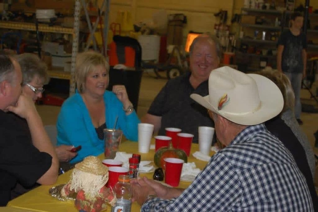 Ernie laughing with friends around a table