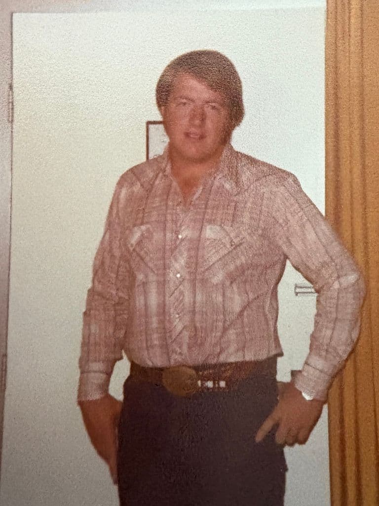A young Ernie in a Western shirt and belt buckle